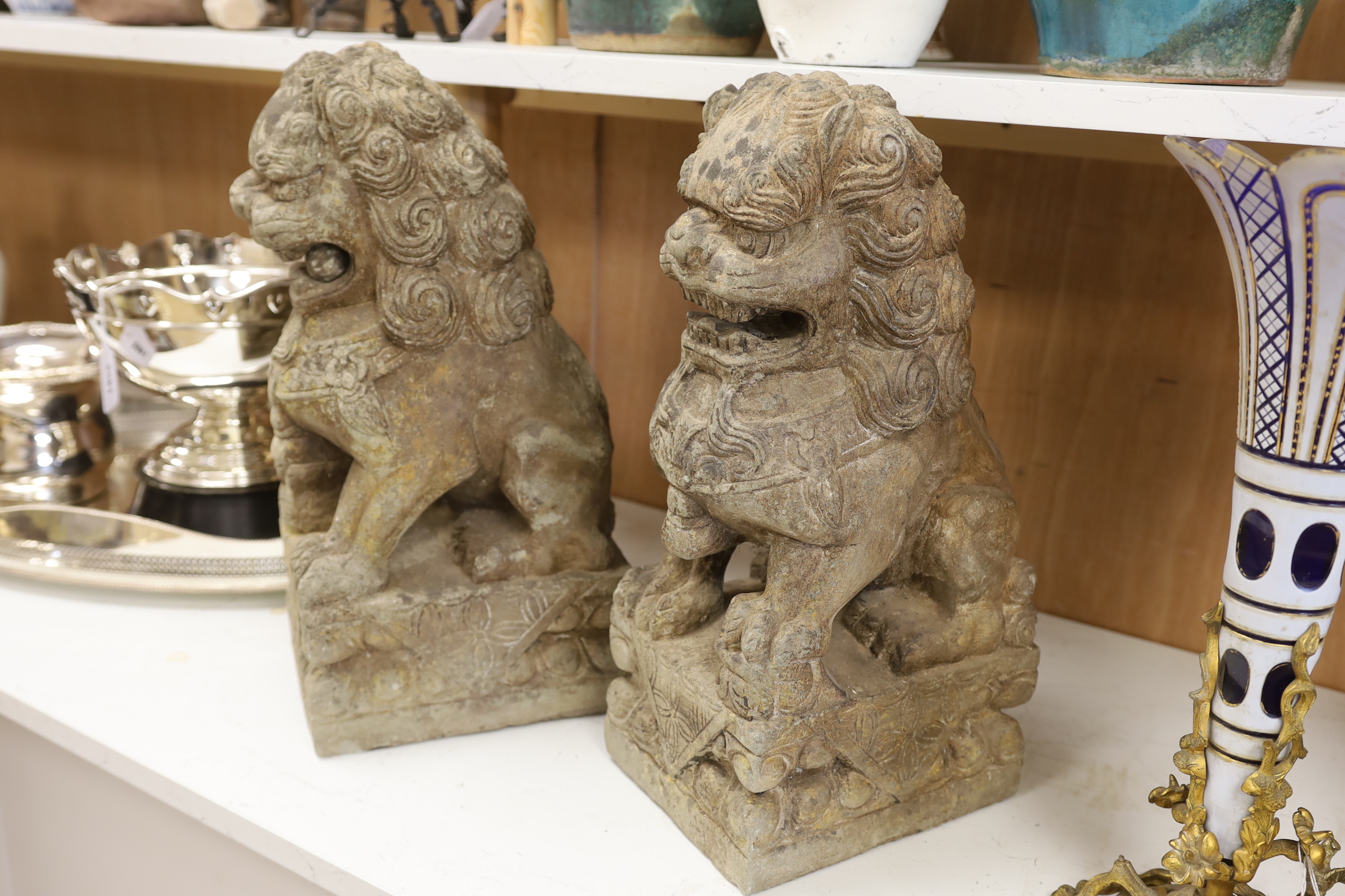A pair of Chinese stone temple dogs, 47cm high
